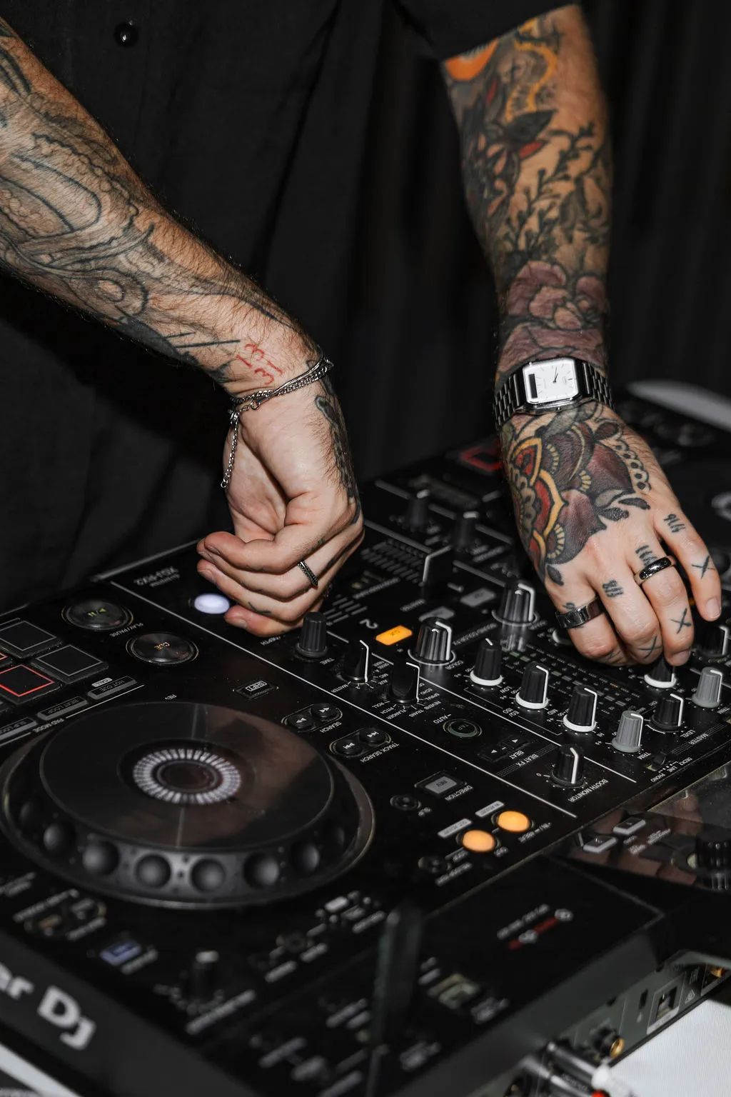 A DJ mixing music at an evening event
