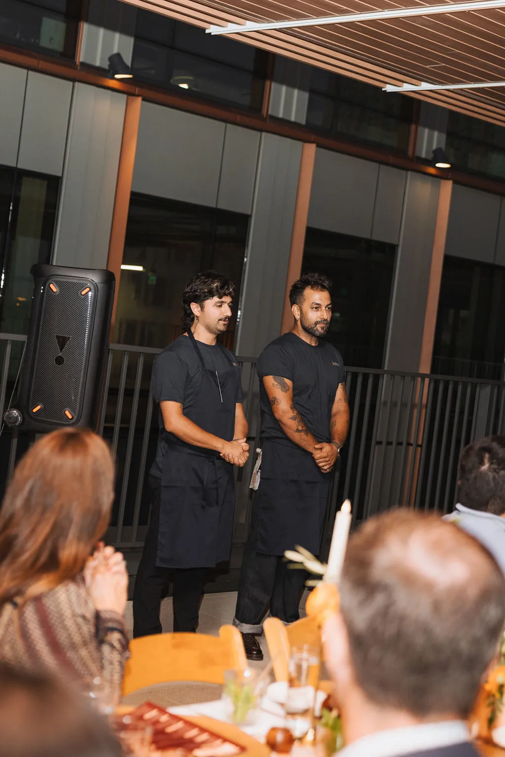 Chefs introducing the menu to seated guests