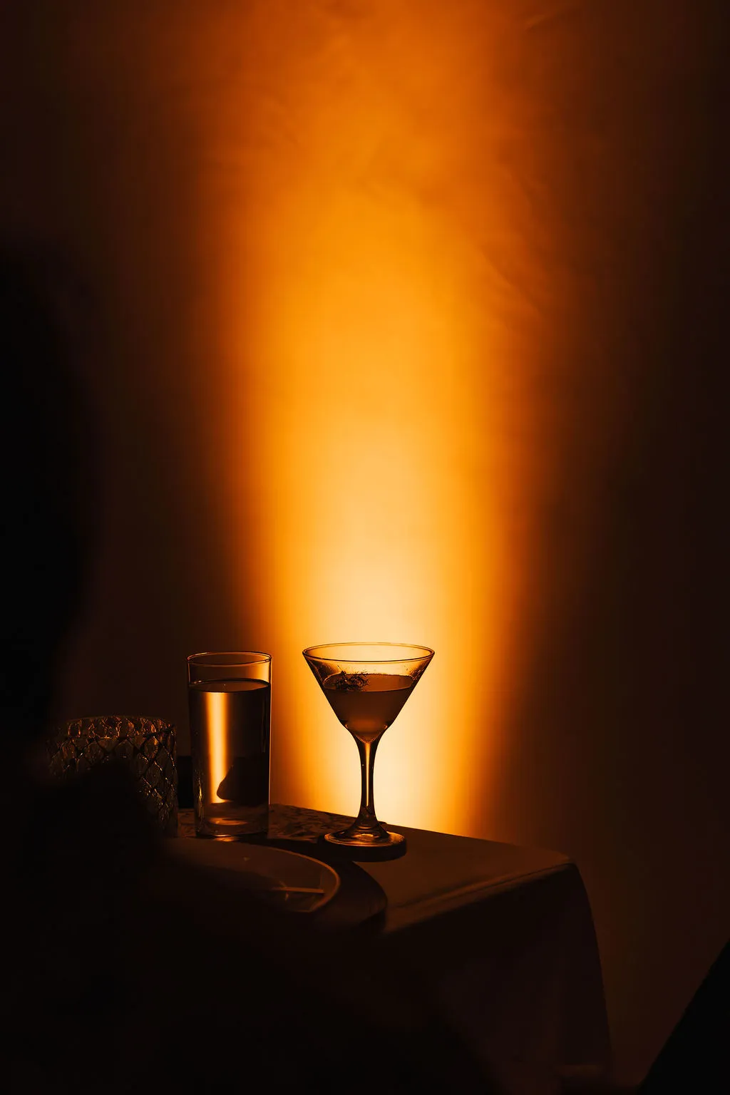 A martini glass glowing under warm light