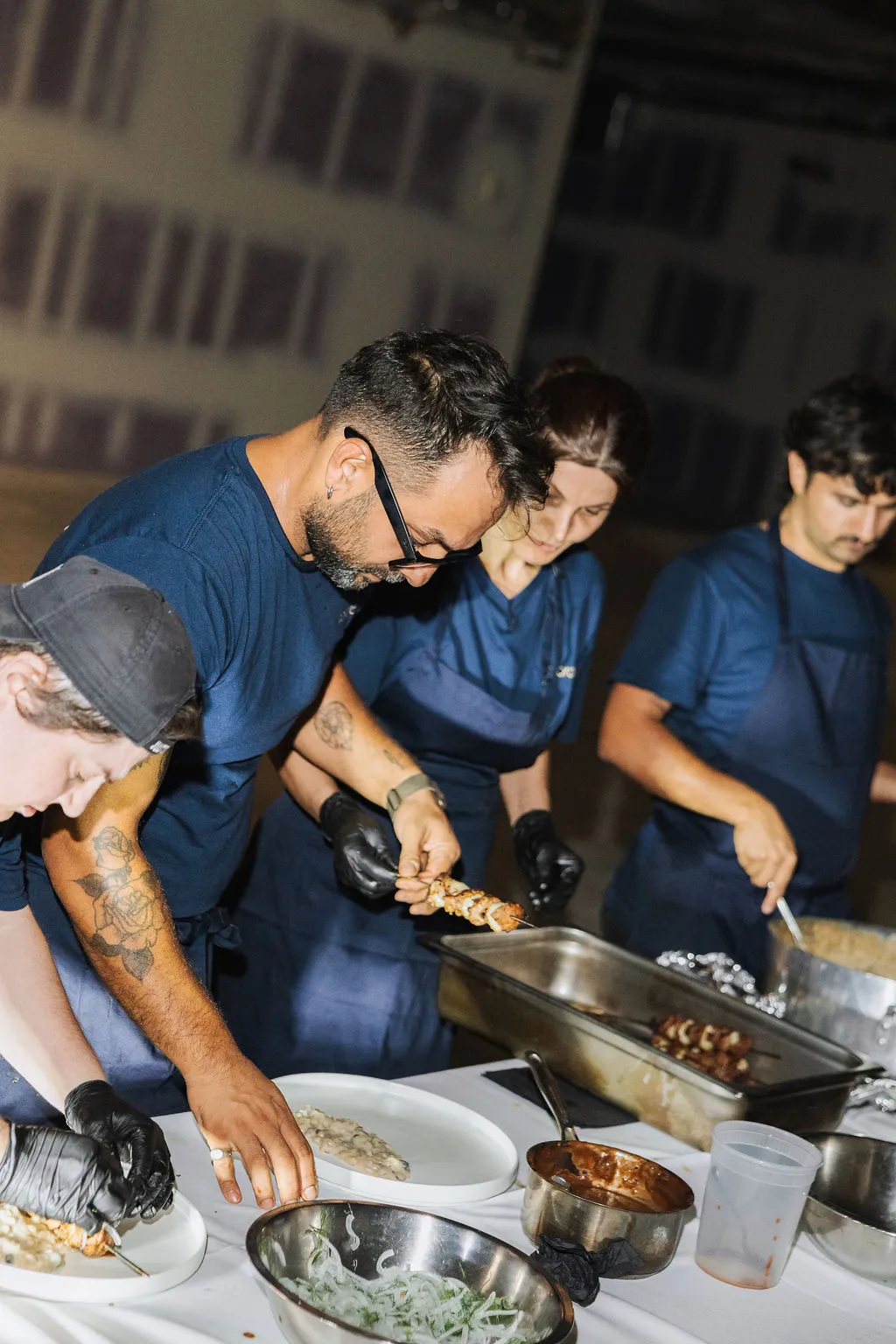 The kitchen team plating courses together