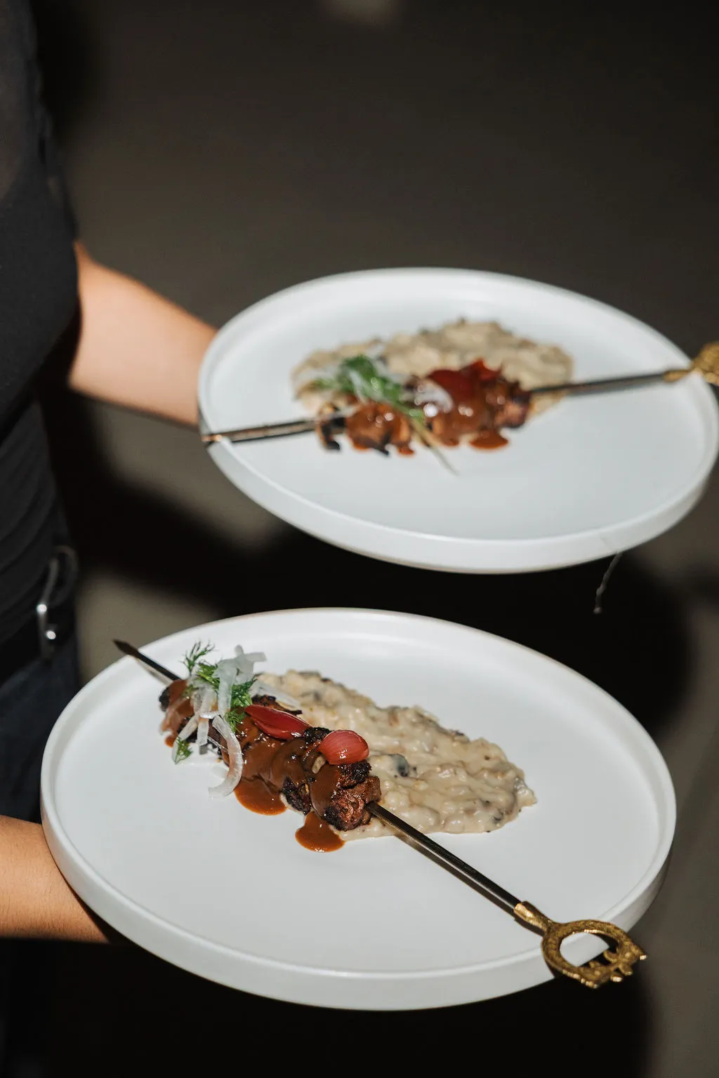 A server carrying two plated courses
