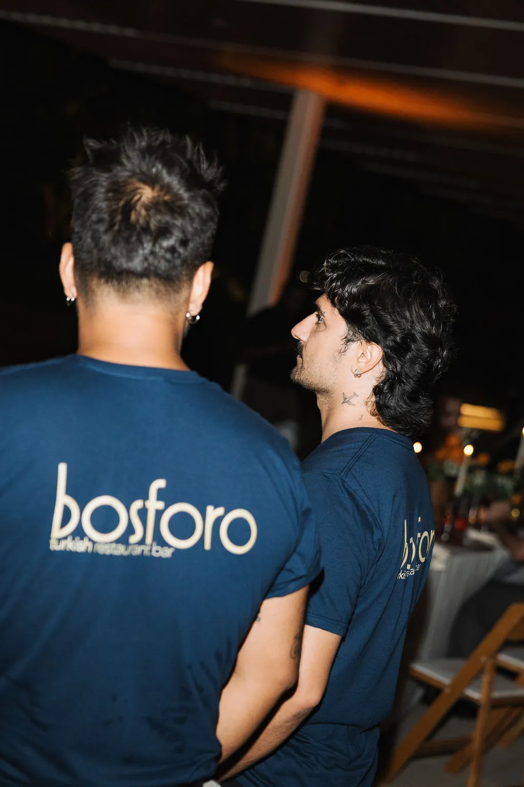 Two Bosforo team members in branded shirts at an event