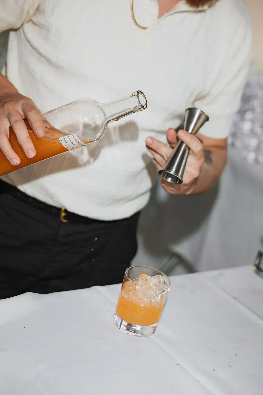 A cocktail being poured and stirred