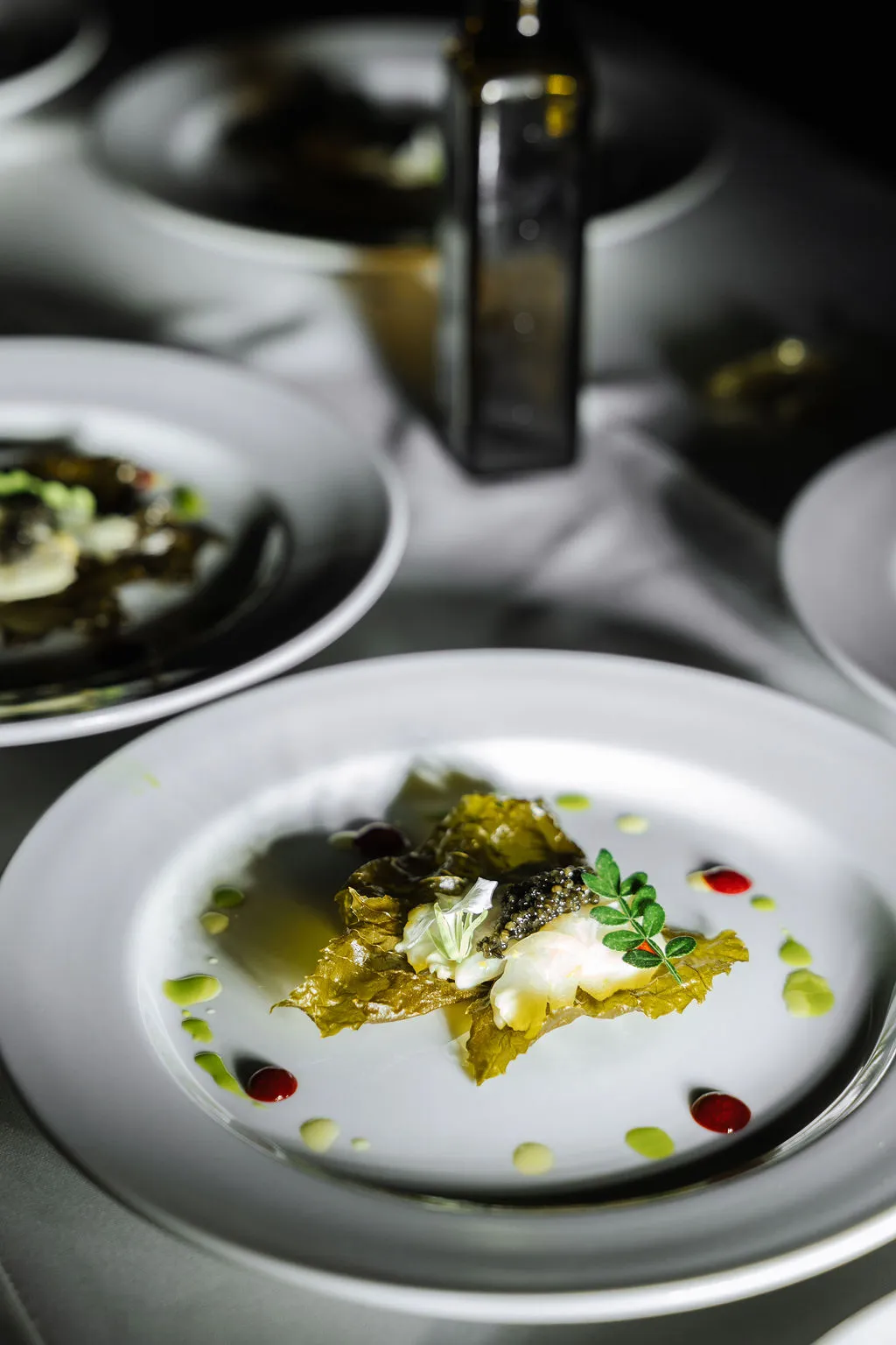 A plated starter with herbs and olive oil